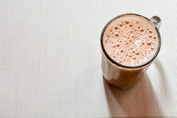 Teh tarik or pulled tea is a famous sweet milk tea in Malaysia. Bubble is floating on the surface of teh tarik.