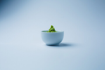wasabi on a light blue background. Close-up. With copy space