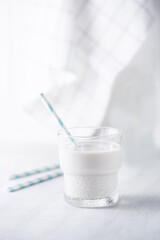 Milk in a glass with paper straw