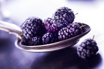 Frozen berries in a spoon close up