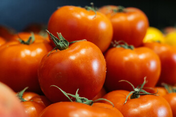 Wet fresh tomatoes on supermarket shelf. Red organic vegetables in grocery store. Healthy vegetarian food, nutrition, dieting.