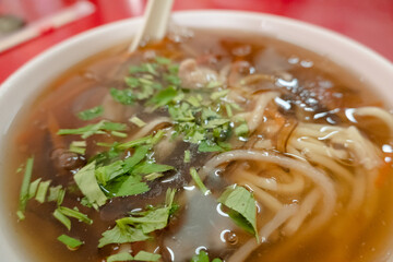 Taiwanese snacks of thickened soup noodles with starch coated pork
