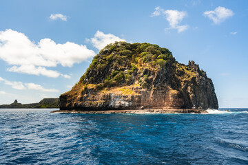 Fototapeta na wymiar Beautiful view of the Ponta da Sapata rocks from the sea at Fernando de Noronha, a Unesco World Heritage site, Pernambuco, Brazil
