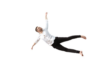 Fototapeta na wymiar Mid-air beauty cought in moment. Full length shot of young man hovering in air and keeping eyes closed. Levitating in free falling, lack of gravity, flying. Freedom, emotions, artwork concept.