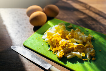 Hard-boiled eggs. Sliced on a green Board. Kitchen.Meal
