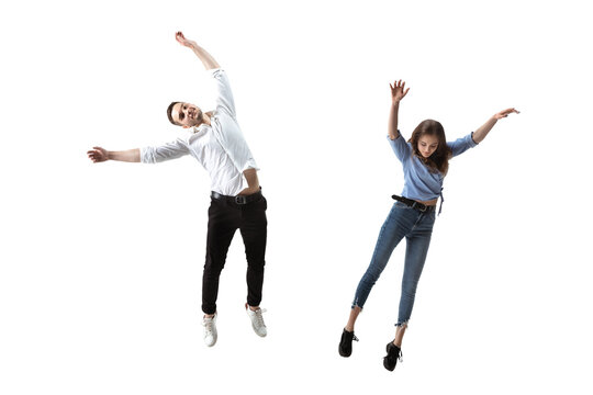 Mid-air beauty cought in moment. Full length shot of attractive young woman and man hovering in air and keeping eyes closed. Levitating in free falling, lack of gravity. Freedom, emotions, artwork