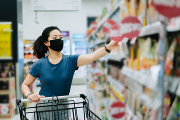 Young Asian woman wear a black face mask are shopping in supermarket, 