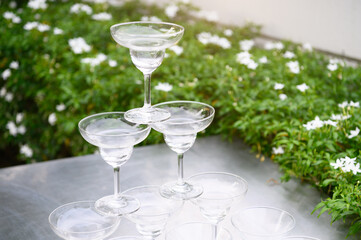 Closeup group of stacking martini wine glasses on outdoors counter bar