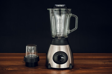 blender standing on wooden countertop on dark background