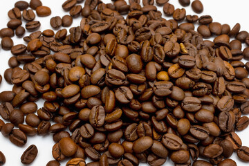 Close up Roasted coffee beans pile isolated on white background. top view