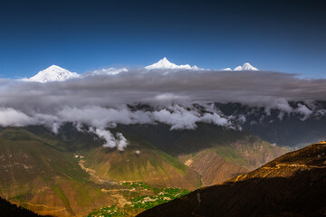 Meili snow mountain, a sacred mountain in Tibet, China, with cloud in middle.
