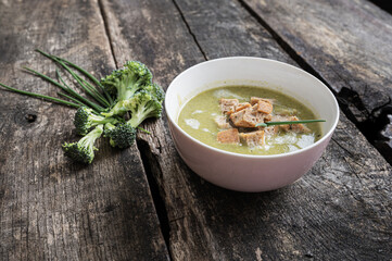 Pink bowl of creamed broccoli soup