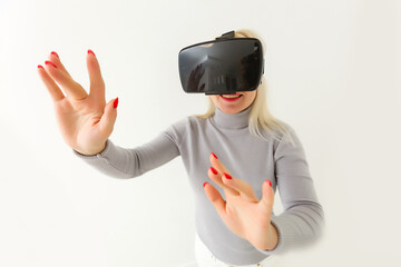 Future is now. Attractive young woman adjusting her VR headset and smiling while sitting at home