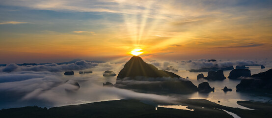 Fototapeta na wymiar landscape limestone and morning mist and the sunrise with blue sky background at Samet Nangchee