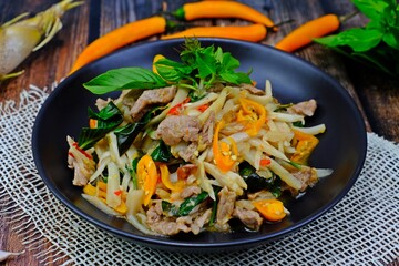 Authentic Thai stir fried spicy preserved sour bamboo shoot with meat.