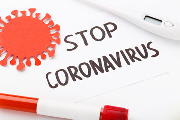 Obraz premium Text Stop Coronovirus with thermometer and test tube on white background