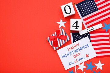 Text Happy Independence Day with flags, gift box and cube calendar on red background