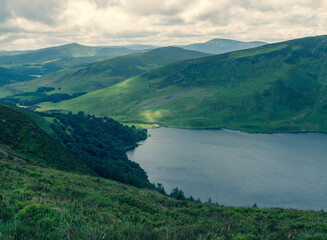 Fototapeta na wymiar Panoramic view of The Guinness Lake (Lough Tay) - a movie and series location, such as Vikings. Close to Dublin City, popular tourist destination.