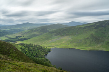 Fototapeta na wymiar Panoramic view of The Guinness Lake (Lough Tay) - a movie and series location, such as Vikings. Close to Dubnlin City, popular tourist destination.