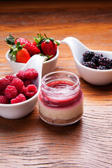 Nutrition concept - Healthy cheese cake in glass jars over wooden background. Healthy food, Diet, Detox, Clean Eating or Vegetarian concept. Delicious dessert option.
