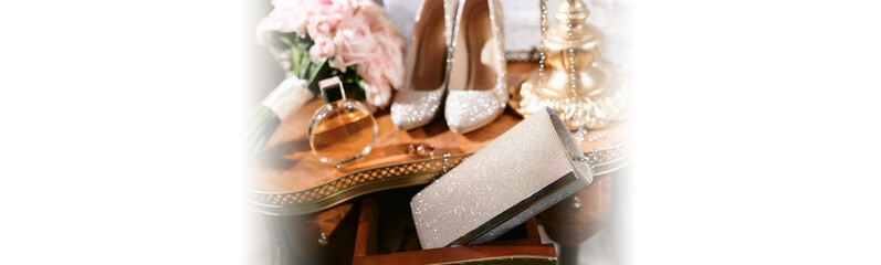 Elegant wedding accessories of an attractive bride. Wedding rings, shoes, bridal bouquet, floral...