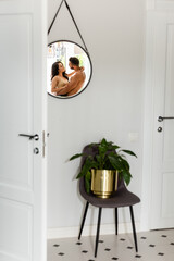 selective focus of mirror with reflection of couple hugging at home