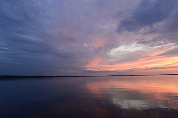 Naklejka premium Lake blue calm water under the twilight summer sky