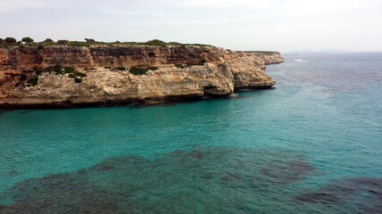 Fototapeta na wymiar Rocky coast and bay with turquoise water in Majorca, Spain