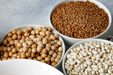 White ceramic bowls with assorted grains on kitchen table