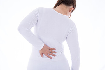 A woman feeling exhausted and suffering from waist and back pain and injury on isolated white background. Health care and medical concept.