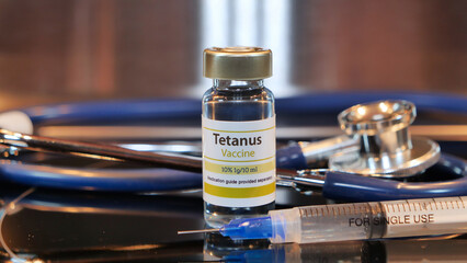 Vial of tetanus vaccine with syringe and stethoscope