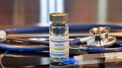 Obraz na płótnie Canvas Vial of Meningococcal vaccine whit syring and stethoscope