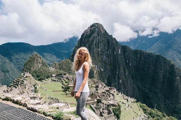 Keuken foto achterwand Machu Picchu Half length portrait of cheerful female hiker with cutest smile on face enjoying trekking tour for exploring natural environment near Machu Picchu, carefree woman feeling happiness at green landscape