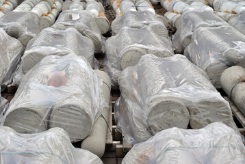 Concrete Products Wrapped in White Plastic on Pallets for Distribution 