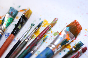 Colorful background of paint brushes, close up 