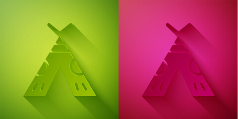 Paper cut Traditional indian teepee or wigwam icon isolated on green and pink background. Indian tent. Paper art style. Vector Illustration © Kostiantyn