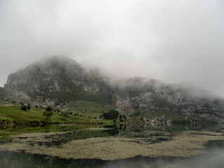 Fototapeta na wymiar Misty valley with a lake