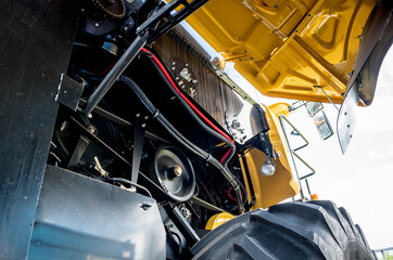 Fototapeta na wymiar Harvester engine. Gear chains and new modern mechanisms.