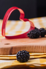 Blackberry love concept. Ripe forest berry and heart shape.