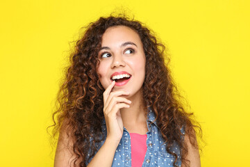 Young american girl on yellow background
