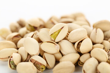 Tasty pistachios on white background