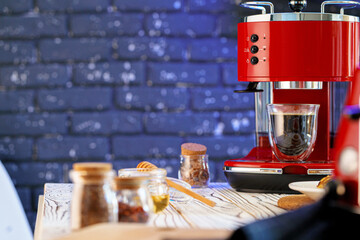 Red coffee machine with a glass on kitchen counter