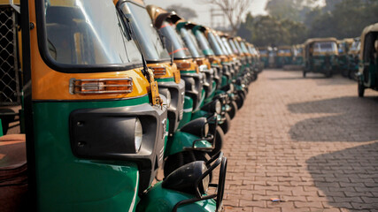 Indian taxi rickshaws exposed in a row.