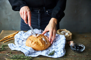Woman Slicing Bread on table