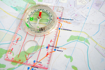 travel sport compass lies on a map to determine azimuth movement