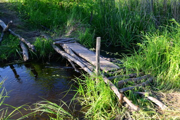 
A small wooden bridge over the river.