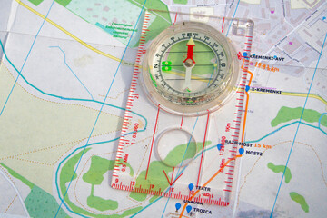 Fototapeta na wymiar travel sport compass lies on a map to determine azimuth movement