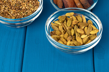 Spices in plate on wooden table close up