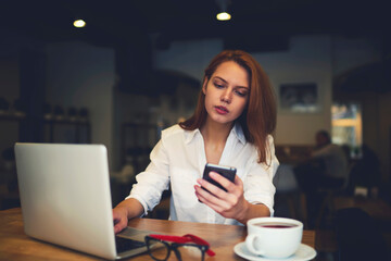 Skilled female administrative manager checking email box waiting for booking confirmation via...