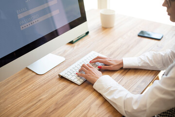 Shot of unrecognizable businesswoman typing on computer's keyboard